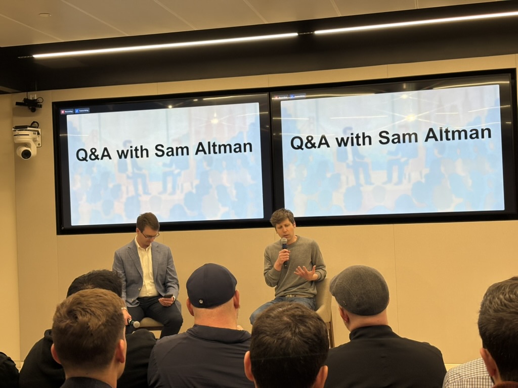 Sam Altman thinking about a question; Matt Knight preparing to fire the next one